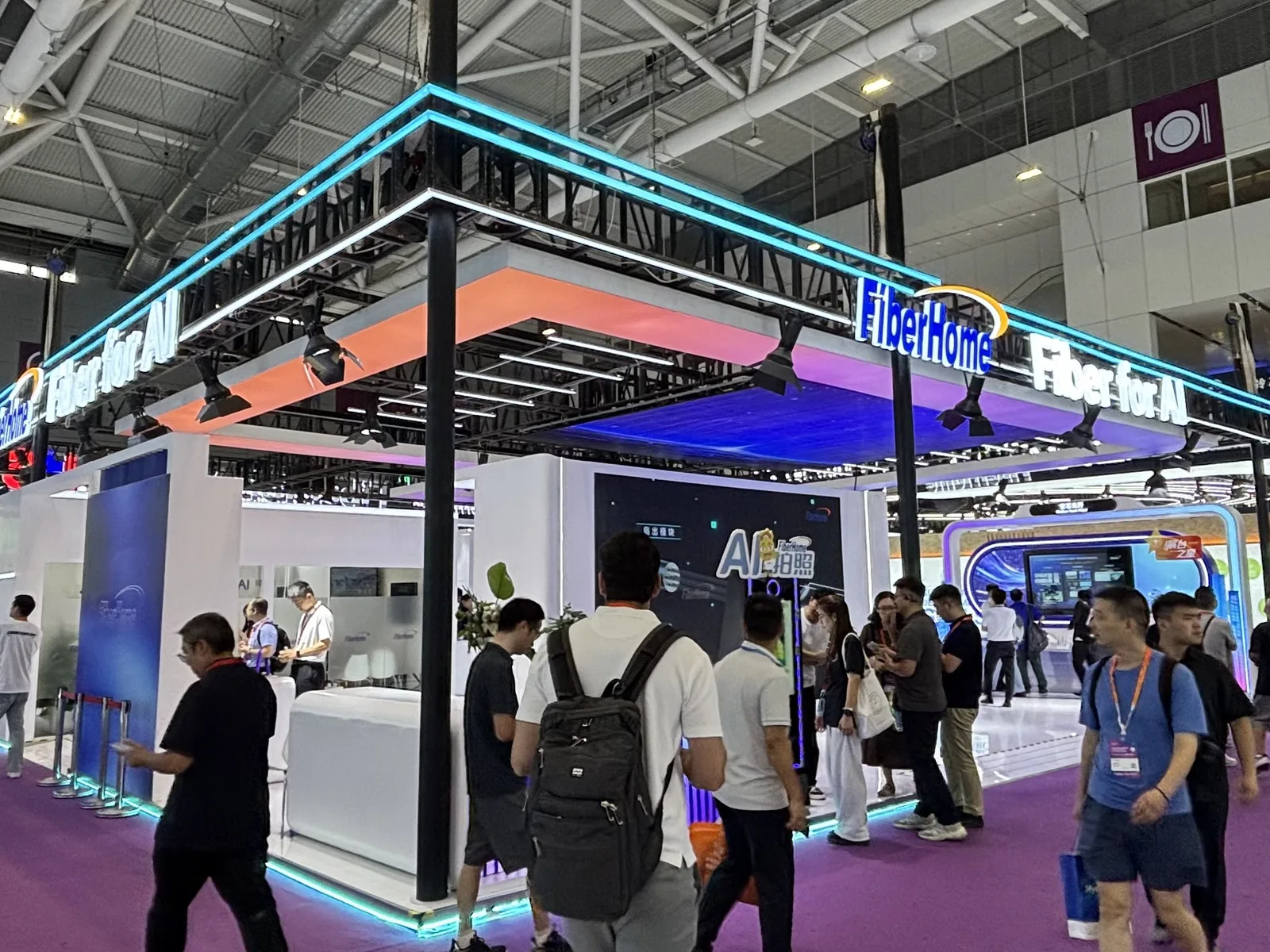 Photograph of the FiberHome booth at CIOE 2026 featuring Fiber for AI branding and 10G PON access solutions