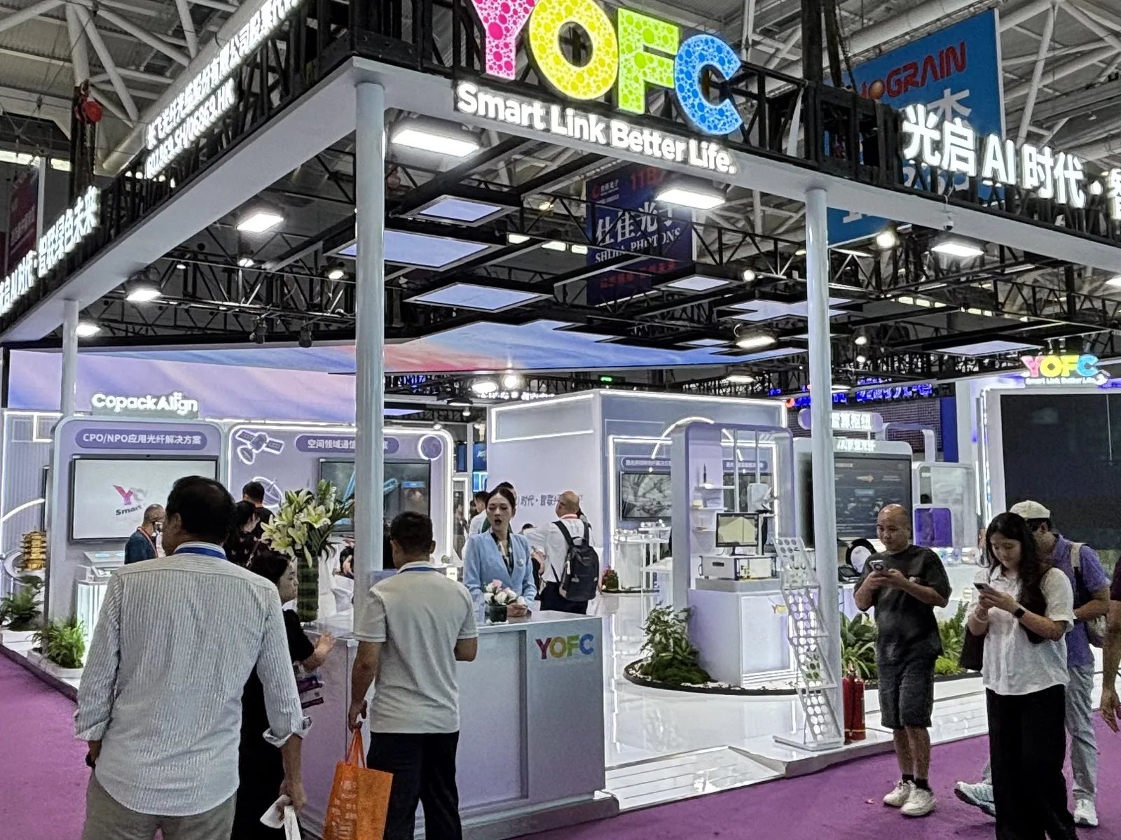 Photograph of the YOFC (Changfei Fiber) booth at CIOE 2026 displaying specialty and hollow-core fiber solutions for AI-era connectivity
